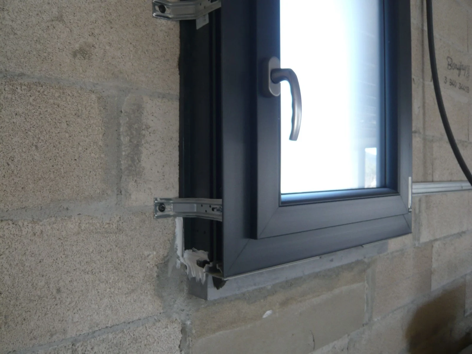 Fenêtre posée en applique contre le mur intérieur d'une construction